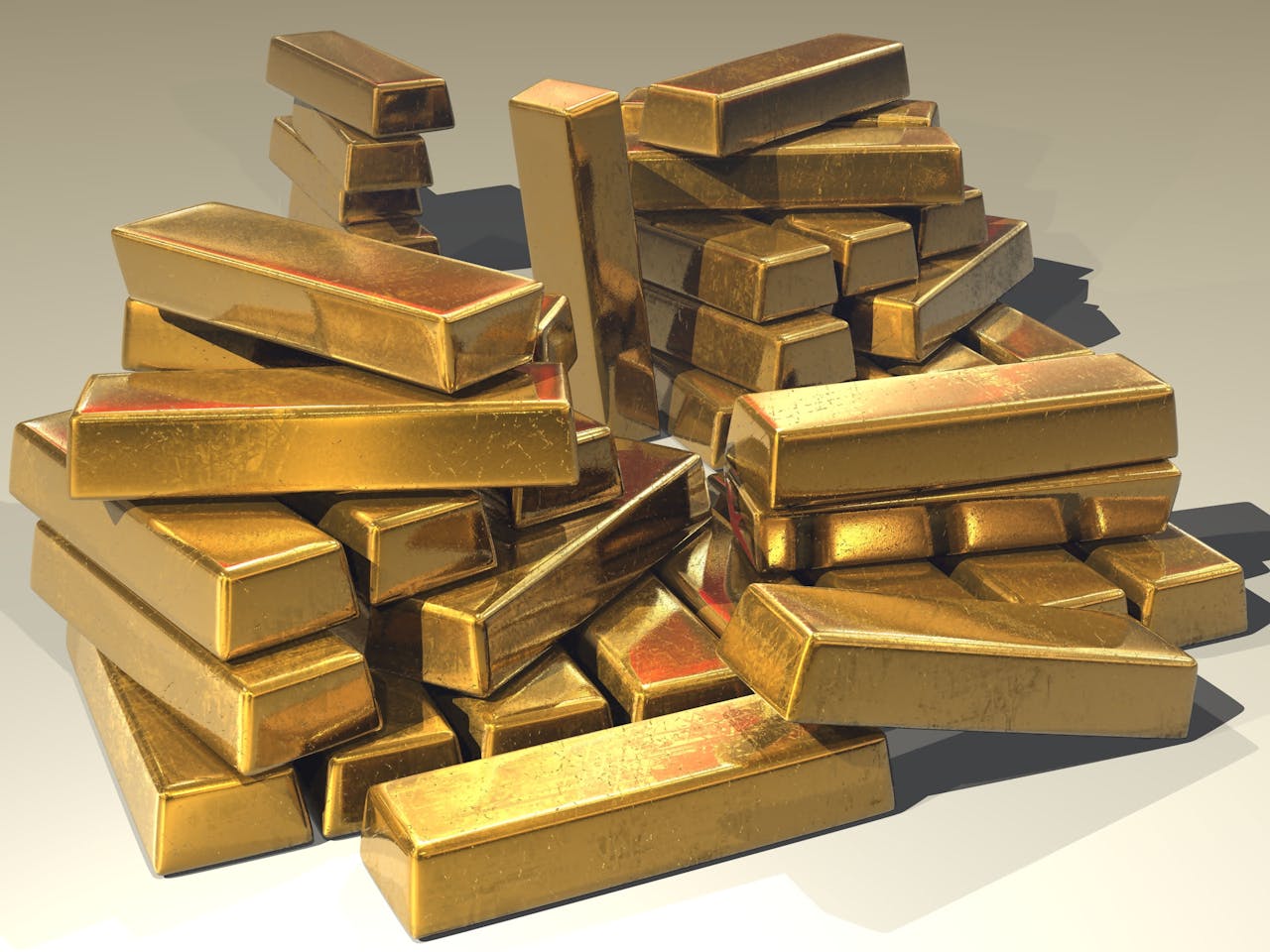 gold-ingots-golden-treasure-47047 A pile of lustrous gold bars symbolizing wealth and prosperity.