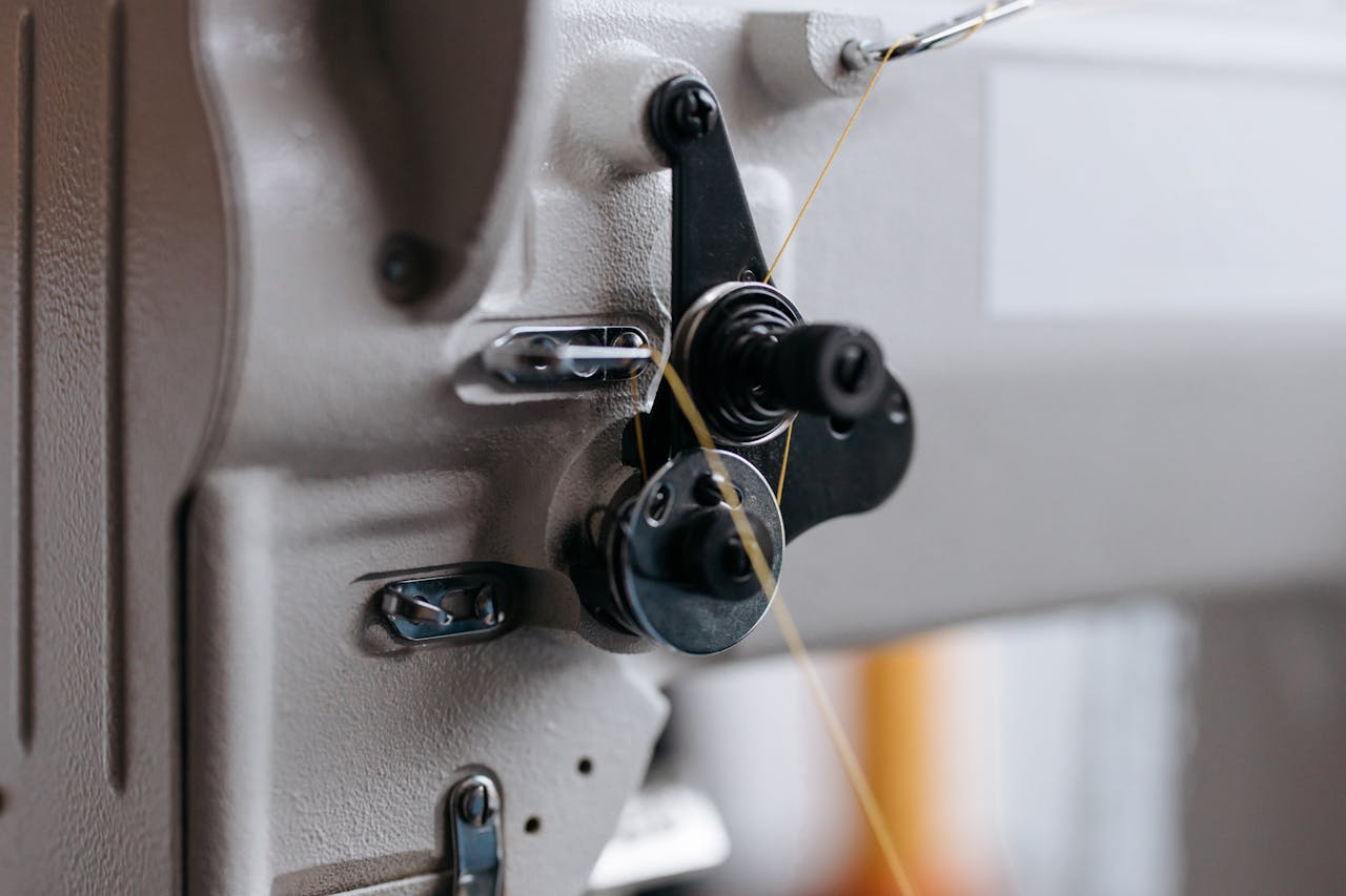pexels-photo-6660919 Detailed view of an industrial sewing machine component, highlighting its intricate mechanics.