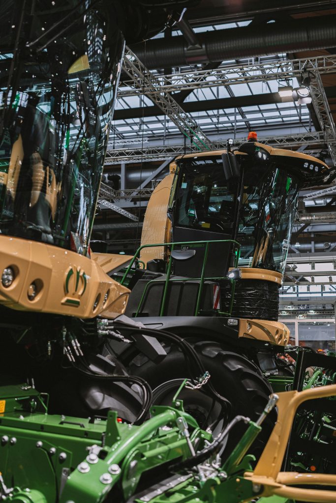 Close-up of advanced agricultural machinery displayed at an indoor exhibition, showcasing modern farming technology.